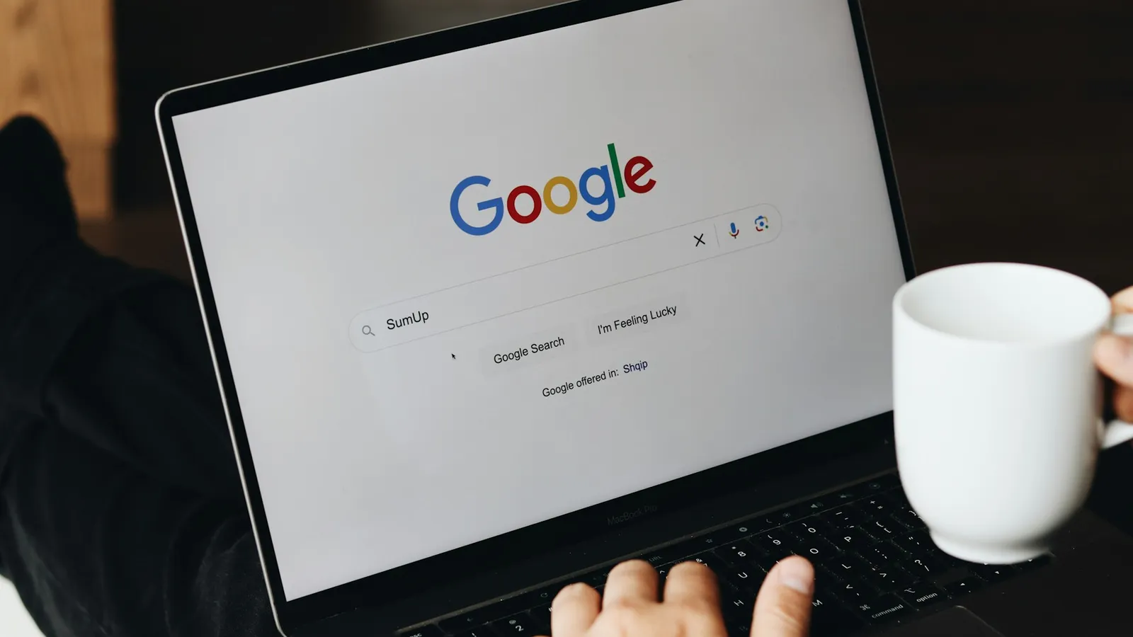 Buyer searching for property on Google on a laptop before visiting a real estate agency website