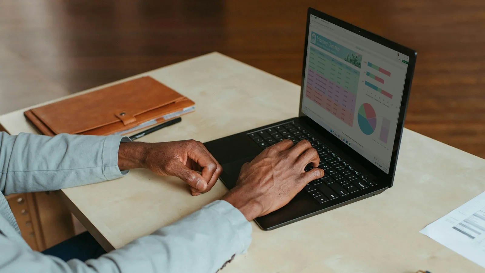 Real estate agent performance dashboard with charts on a laptop