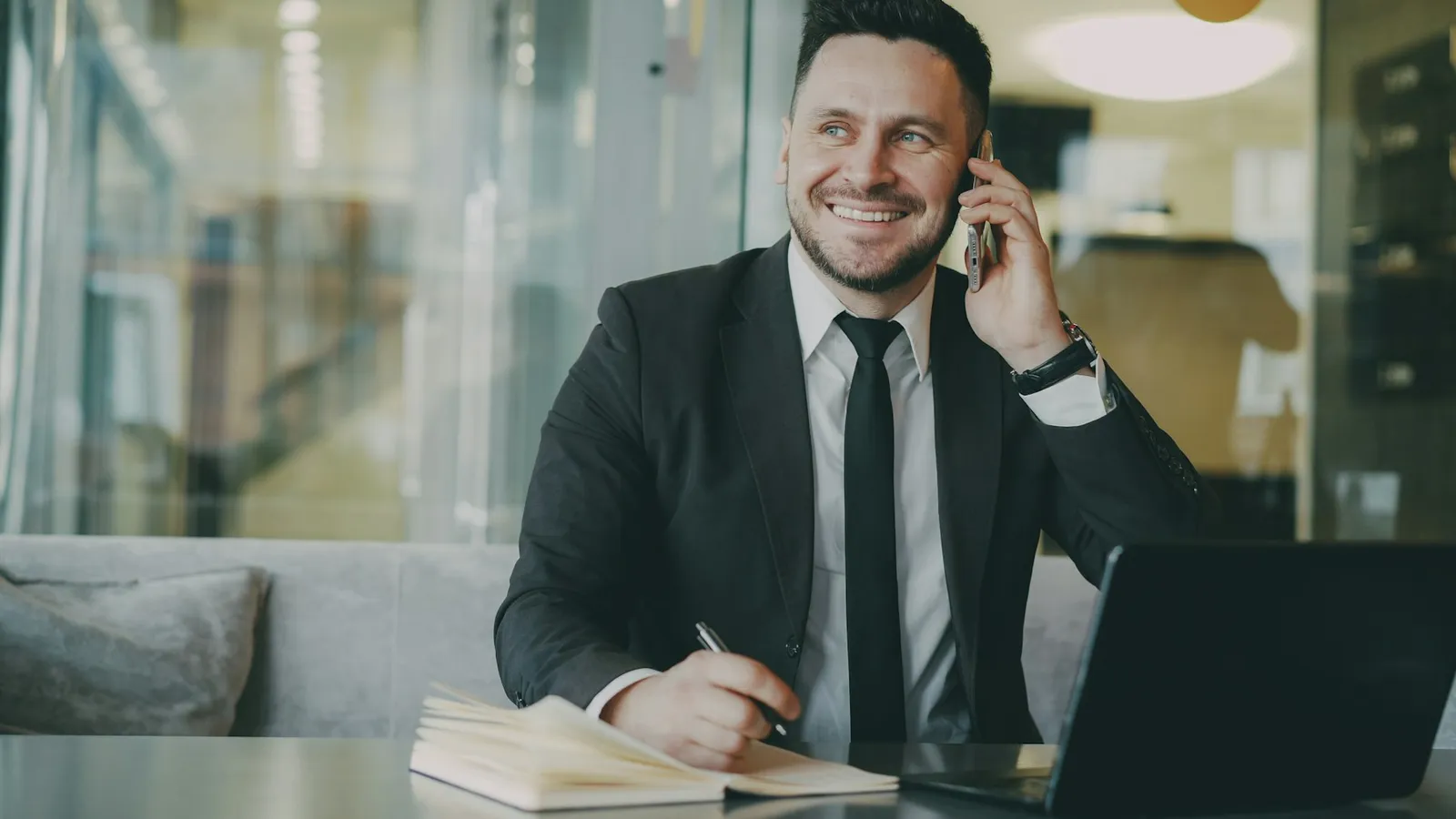 Real estate agent on the phone with a buyer after a WhatsApp enquiry was assigned to him in the CRM